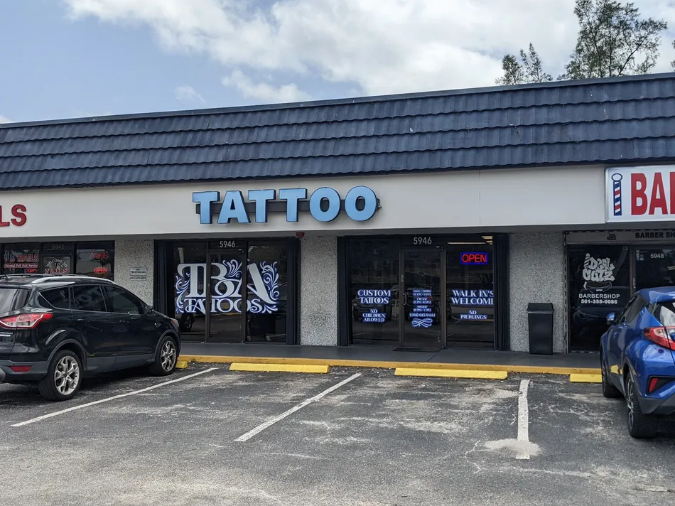 The TBA Tattoos storefront on Okeechobee Blvd in West Palm Beach, with its red Tattoo sign