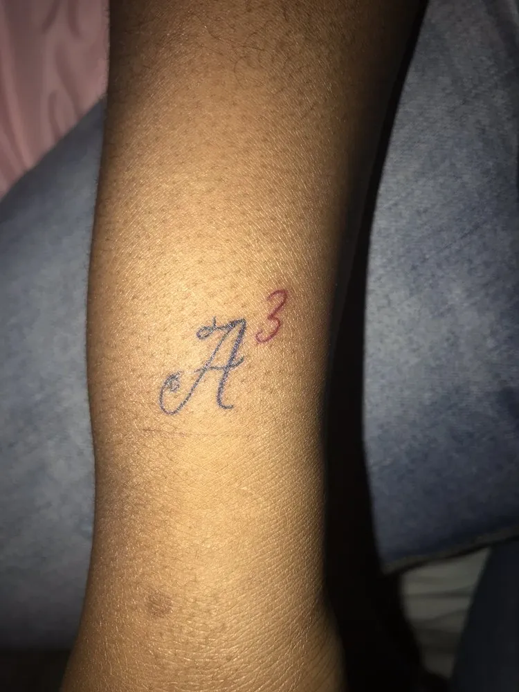 Small script lettering tattoo on a client's forearm, tattooed at TBA Tattoos in West Palm Beach