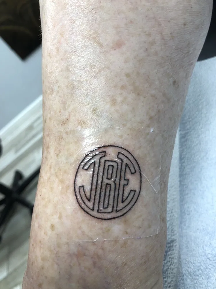 Circular interlaced monogram lettering tattoo, tattooed at TBA Tattoos in West Palm Beach
