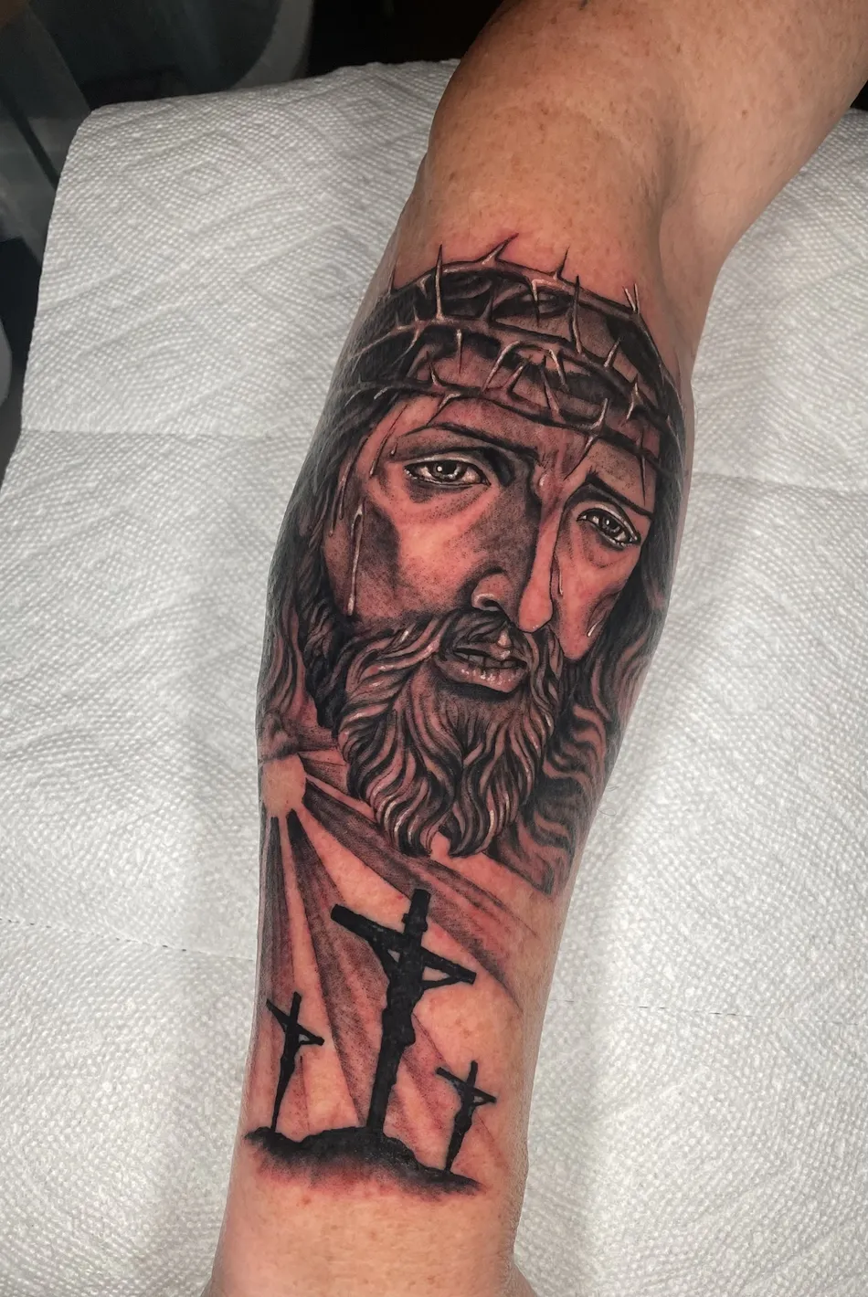 Black and grey realism portrait tattoo on a client's forearm, tattooed at TBA Tattoos in West Palm Beach